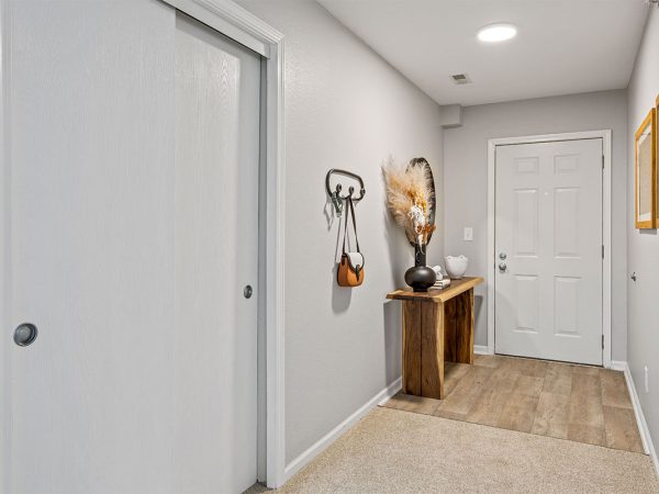 apartment entrance with table and key hanger