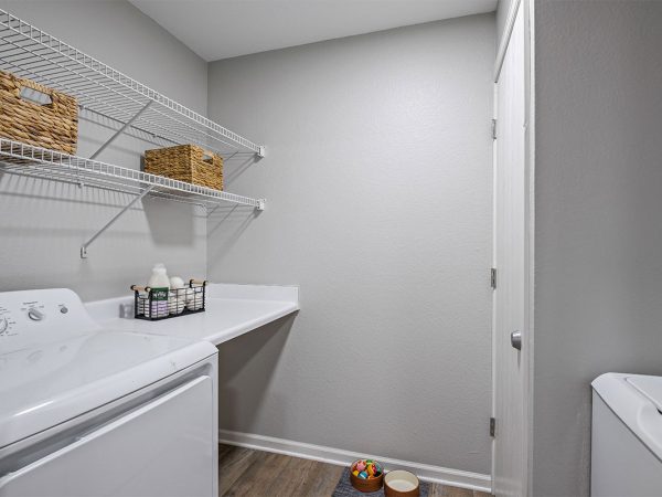 laundry room with in unit washer and dryer and shelves