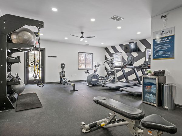 fitness room with a bench and cardio equipment